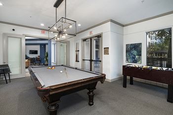 Game room with billiards, shuffleboard and foosball